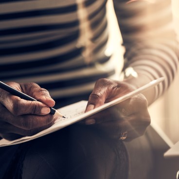 Hands of a man making notes